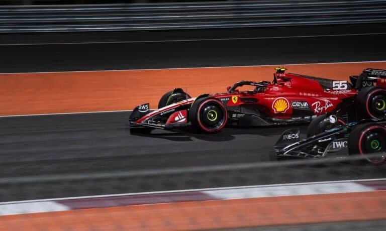Dynamic shot of a Formula 1 race car speeding on a night track in Doha, Qatar.