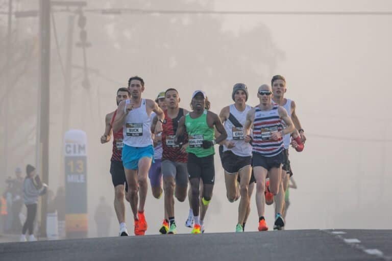Athletics and Marathon, the classic endurance test. Runners on city bridge.Pexel