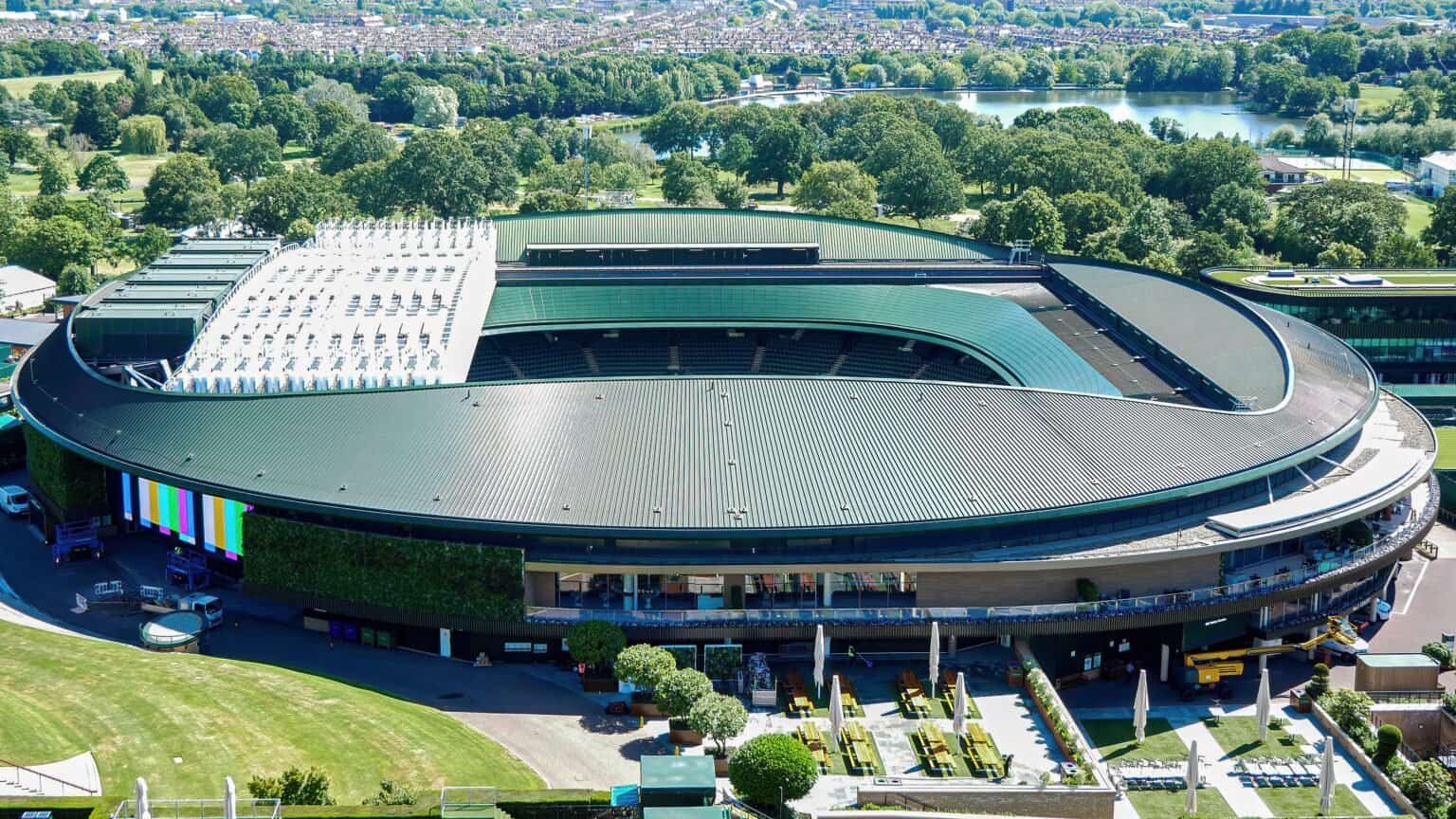 Aerial view of Centre Court at the All England Club, with Wimbledon Park behind it