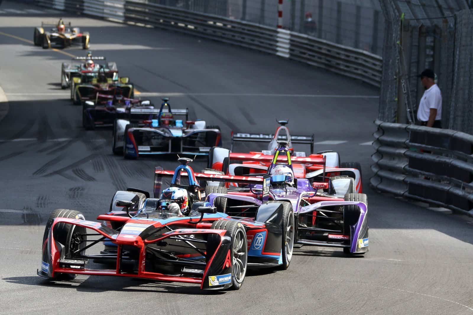 Formula E cars racing between the barriers on the streets of Monaco