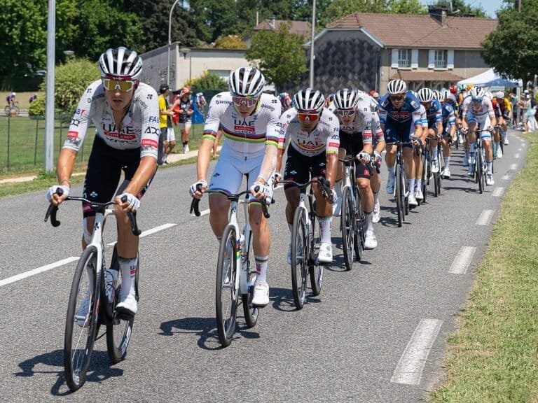 Pogačar crash. Tadej Pogacar riding surrounded by other riders inside the peloton